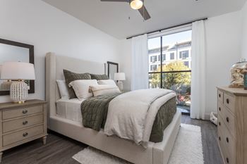 Contemporary bedroom with neutral tones and large window